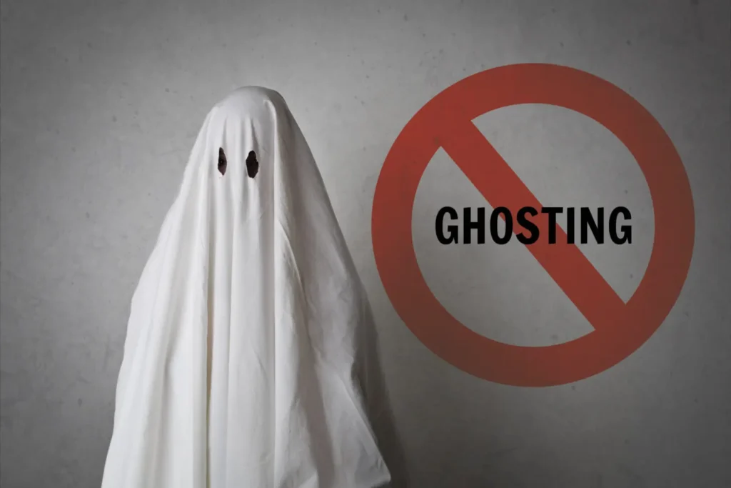 A person wearing a white cloth beside a ghosting sign